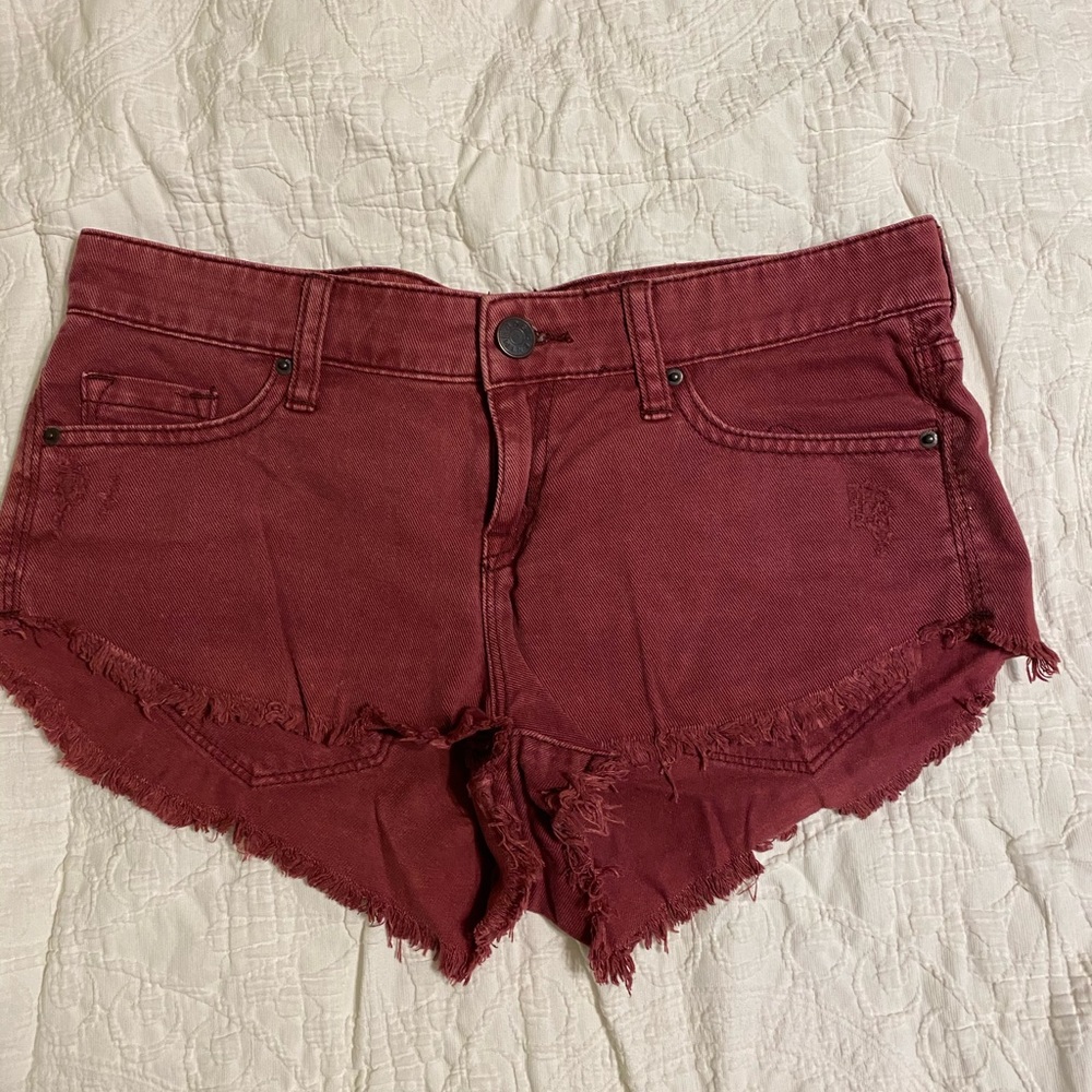Maroon low rise dolphin denim shorts